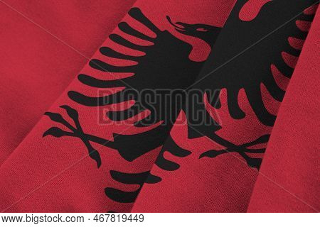 Albania Flag With Big Folds Waving Close Up Under The Studio Light Indoors. The Official Symbols And