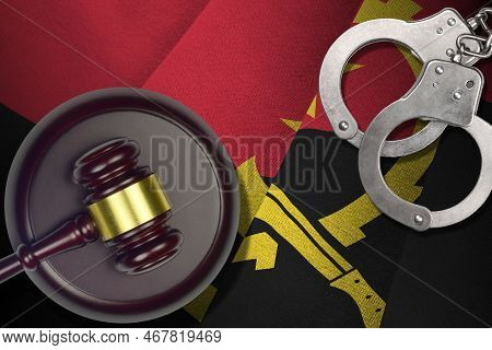 Angola Flag With Judge Mallet And Handcuffs In Dark Room. Concept Of Criminal And Punishment, Backgr