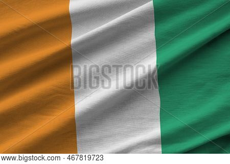 Ivory Coast Flag With Big Folds Waving Close Up Under The Studio Light Indoors. The Official Symbols