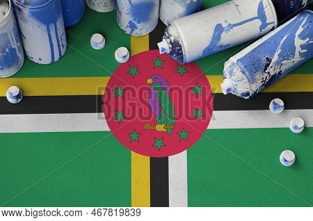 Dominica Flag And Few Used Aerosol Spray Cans For Graffiti Painting. Street Art Culture Concept, Van