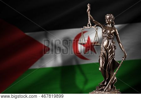 Western Sahara Flag With Statue Of Lady Justice And Judicial Scales In Dark Room. Concept Of Judgeme