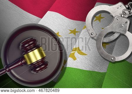 Tajikistan Flag With Judge Mallet And Handcuffs In Dark Room. Concept Of Criminal And Punishment, Ba