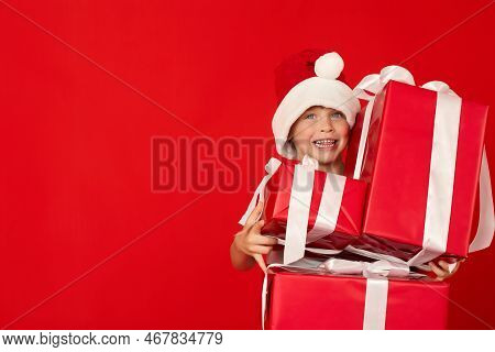 Satisfied Child Holds Three Large Gift Boxes Given To Him For The Holiday. Cheerful Boy Received Man