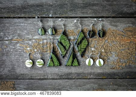 Close Up Earrings With Fern Leaves Set Concept Photo. Handmade Jewelry. Top View Photography With Wo