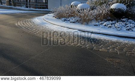 Roundabout Of Paving Gray Granite Cubes, Transport Hub, With Flowers And Grasses In The Middle Of Th