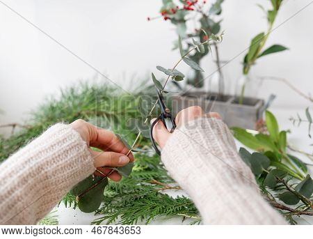 The Process Of Making A Christmas Wreath From Needles, Thuja, Shimia, Rosehip, Pine Twigs, Chopped T