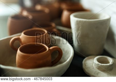 A Close-up Of Various Drying Clay Tableware On A Shelf. A Pottery Studio Concept. Craftmade Dishes, 