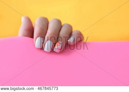 Beautiful Female Hands With A Manicure On A Pink And Orange Background. Shaded Nail Design. Summer M
