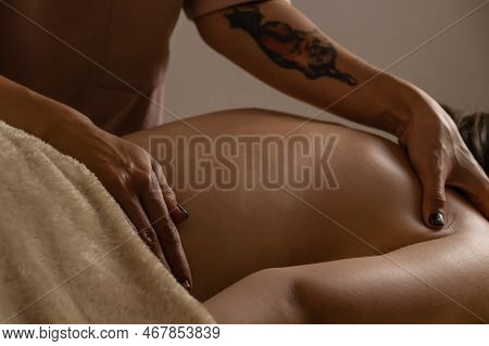 Close-up Of Women's Hands Doing Back Massage To A Girl Lying On A Massage Couch In A Massage Parlor 