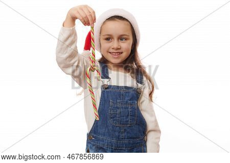 Striped Red Green Candy Canes, Sweet Lollipops In The Hands Of Blurred Smiling Cute Child Girl, Wear