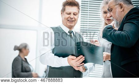 Close Up. Experienced Company Employees Discussing Business Documents