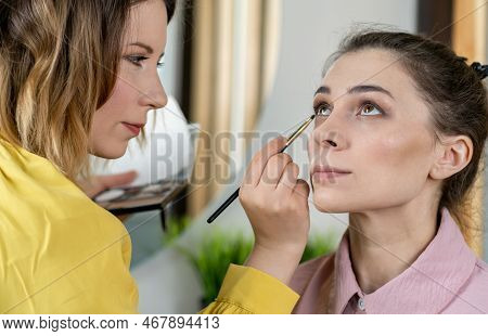 Beauty Stylist Applying Make-up To A Young Model.professional Make-up Artist Doing Glamour