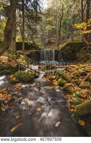 Vlasky River With Waterfall Illuminated With Sun In An Untouched Landscape In The Middle Of An Autum