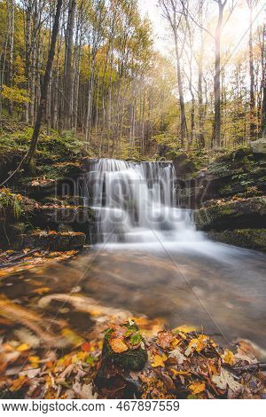 Vlasky River With Waterfall Illuminated With Sun In An Untouched Landscape In The Middle Of An Autum