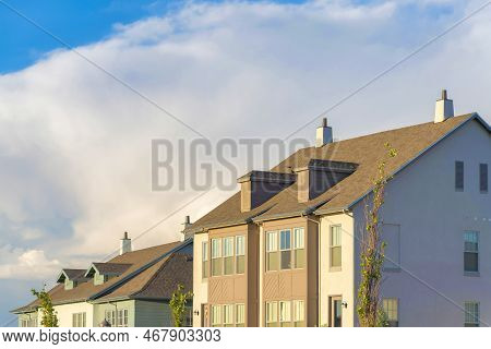 Two Houses With Dormer Roofs At Daybreak In South Jordan, Utah. There Is A House On The Right With L