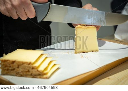 July 11 2022, Lyon, France : A Man Cuts A Portion Of The Vacherin Fribourgeois With A Wire, A Famous