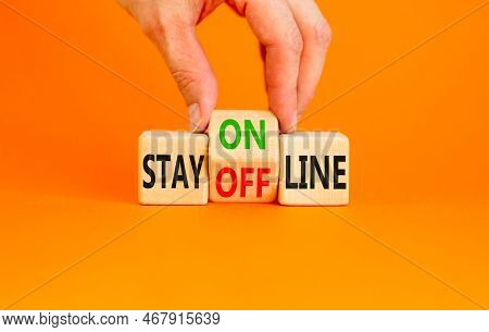 Stay Online Or Offline Symbol. Concept Word Stay Online Or Offline On Wooden Cubes. Businessman Hand