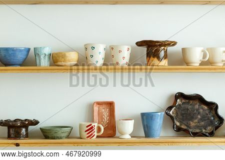 Handmade Ceramic Crockery And Craft Pottery Jug, Jars And Cups Standing On Shelves, Creative Studio 