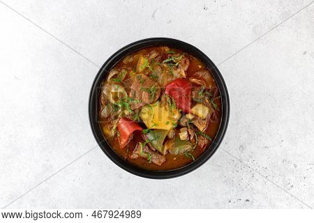 Khashlama Stew Of Beef Or Lamb Meat With Vegetables On A Black Plate, Top View. Armenian And Georgia