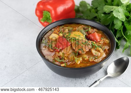 Georgian Or Armenian Meat Khashlama With Vegetables And On A Gray Background. Selective Focus.