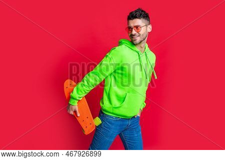 Happy Skater Isolated On Red. Happy Man Skater Holding Pennyboard. Pennyboard Skater