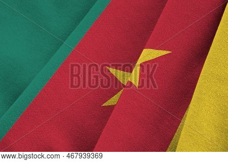 Cameroon Flag With Big Folds Waving Close Up Under The Studio Light Indoors. The Official Symbols An