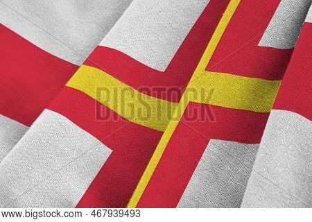 Guernsey Flag With Big Folds Waving Close Up Under The Studio Light Indoors. The Official Symbols An