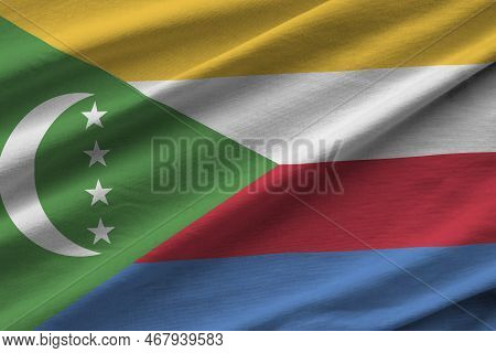 Comoros Flag With Big Folds Waving Close Up Under The Studio Light Indoors. The Official Symbols And