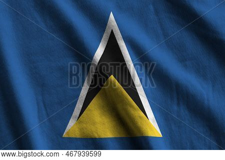Saint Lucia Flag With Big Folds Waving Close Up Under The Studio Light Indoors. The Official Symbols