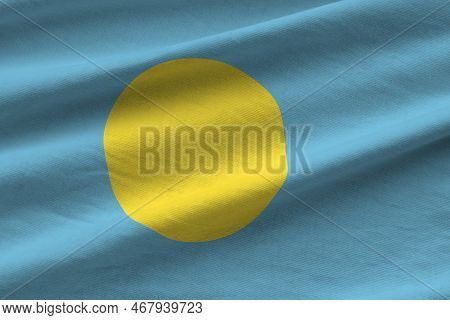 Palau Flag With Big Folds Waving Close Up Under The Studio Light Indoors. The Official Symbols And C