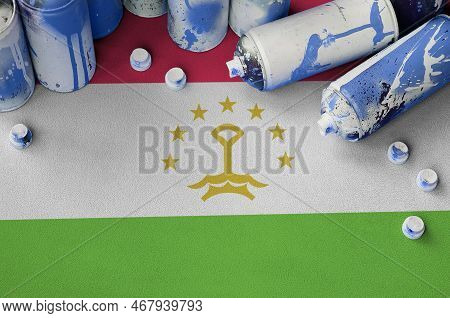 Tajikistan Flag And Few Used Aerosol Spray Cans For Graffiti Painting. Street Art Culture Concept, V