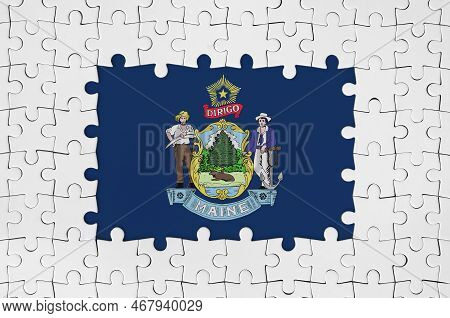 Maine Us State Flag In Frame Of White Puzzle Pieces With Missing Central Parts