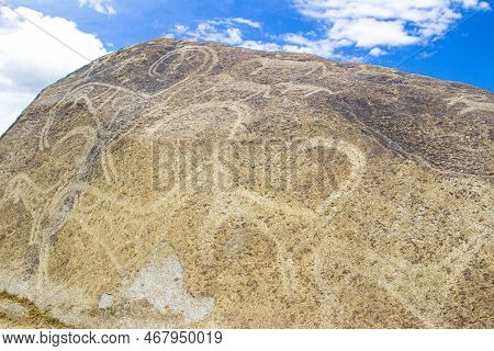 Petroglyphs On The Rocks In Kazakhstan. The Ancient Parking Cave Man. Historical Cave Paintings. Car