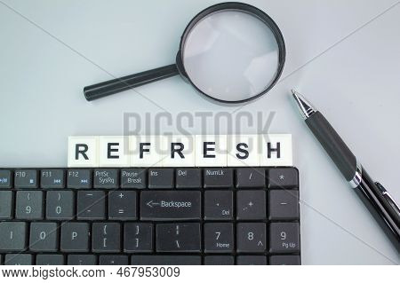 A Magnifying Glass, An Alarm Clock And A Pen With A Restock Of Alphabet Words. The Concept Of Refill