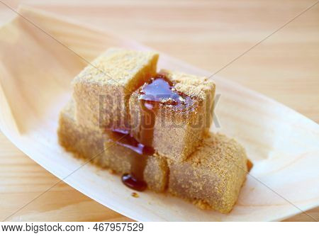 Delectable Japanese Traditional Confection Called Warabimochi Dripped With Kuromitsu Syrup
