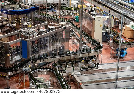 Production Of Cremant Sparkling Wine In Burgundy, France. Automatically Powered Bottling Lines On Fa