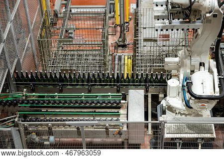 Production Of Cremant Sparkling Wine In Burgundy, France. Automatically Powered Bottling Lines On Fa