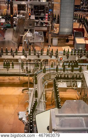 Production Of Cremant Sparkling Wine In Burgundy, France. Automatically Powered Bottling Lines On Fa