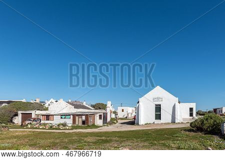 Arniston, South Africa - Sep 22, 2022: A House, Car Wreck And The Hall Of The Kassiesbaai Fishermans