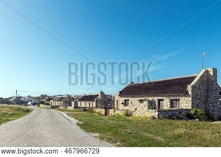 Arniston, South Africa - Sep 22, 2022: A Street Scene, With Thatched Roof Houses, In Kassiesbaai, An