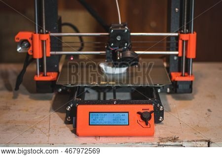 Technological Hi-teg Tool For Making New Things. A Black And Red 3d Printer At Work. The Object Is C