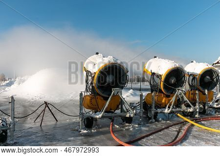 Three Snow Cannons Spray Artificial Snow Crystals. Production Of Artificial Snow. Cars Make Snow. Sn