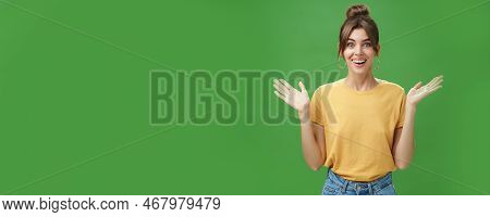 Amazed And Surprised Woman Reacting To Astonishing Gift Raising Hands Near Shoulders Smiling Happily