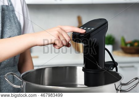 Woman Using Thermal Immersion Circulator In Kitchen, Closeup. Sous Vide Cooking