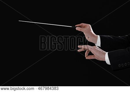 Professional Conductor With Baton On Black Background, Closeup. Space For Text