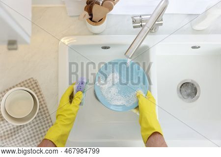 Man Washing Plate In Kitchen Sink, Top View