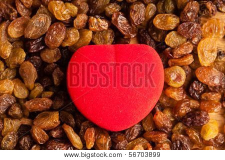 Diet Healthy Food. Raisin As Background Texture And Red Heart