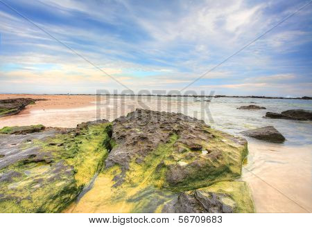 Wispy Clouds And Rocky Tidal Flows