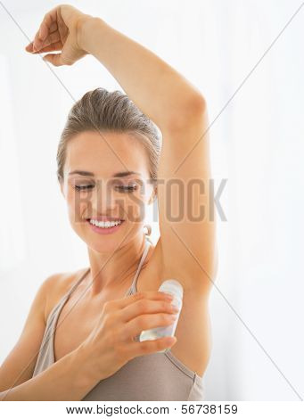 Happy Young Woman Deodorant On Underarm