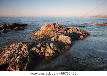 Coriscan Rocks In Sea At Dusk